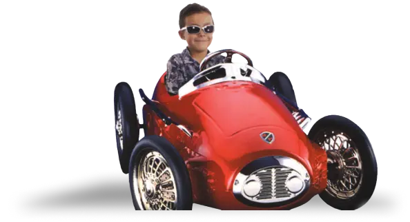 Boy sitting in red toy sports car